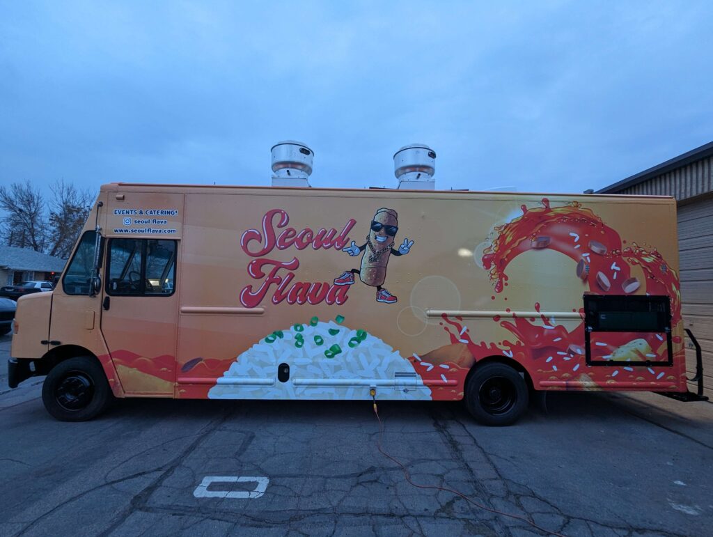 Skilled technicians performing food truck maintenance.