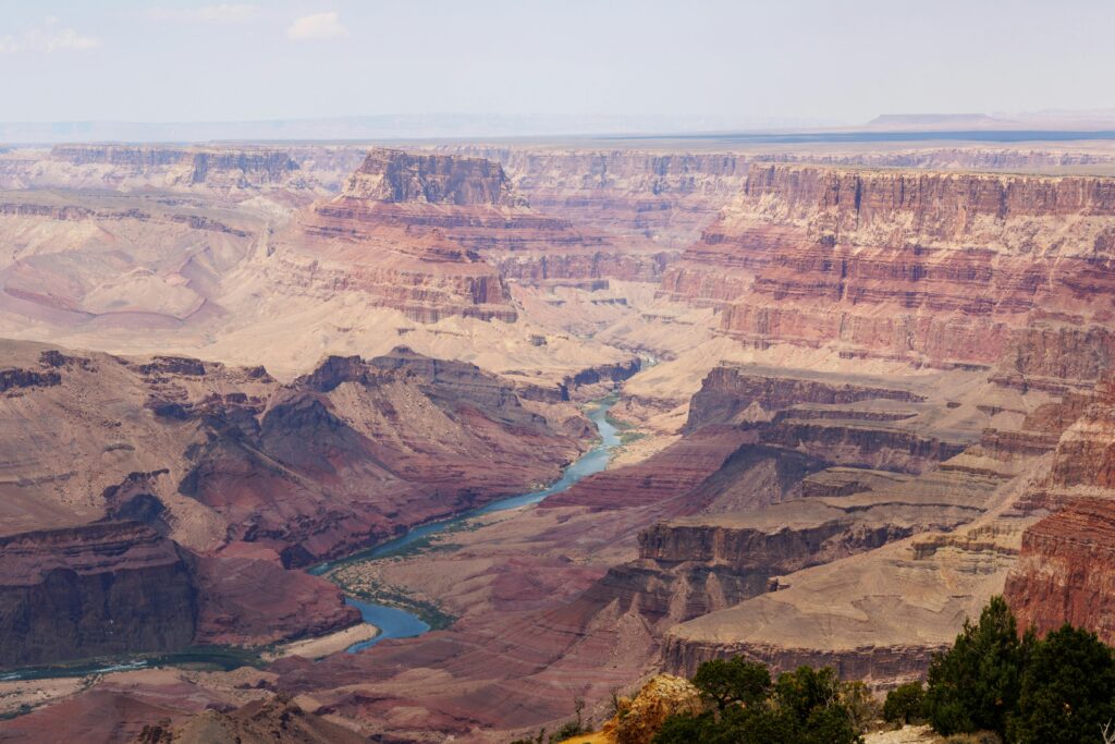 Scenic view of the Grand Canyon with the Colorado River winding through its majestic cliffs.
