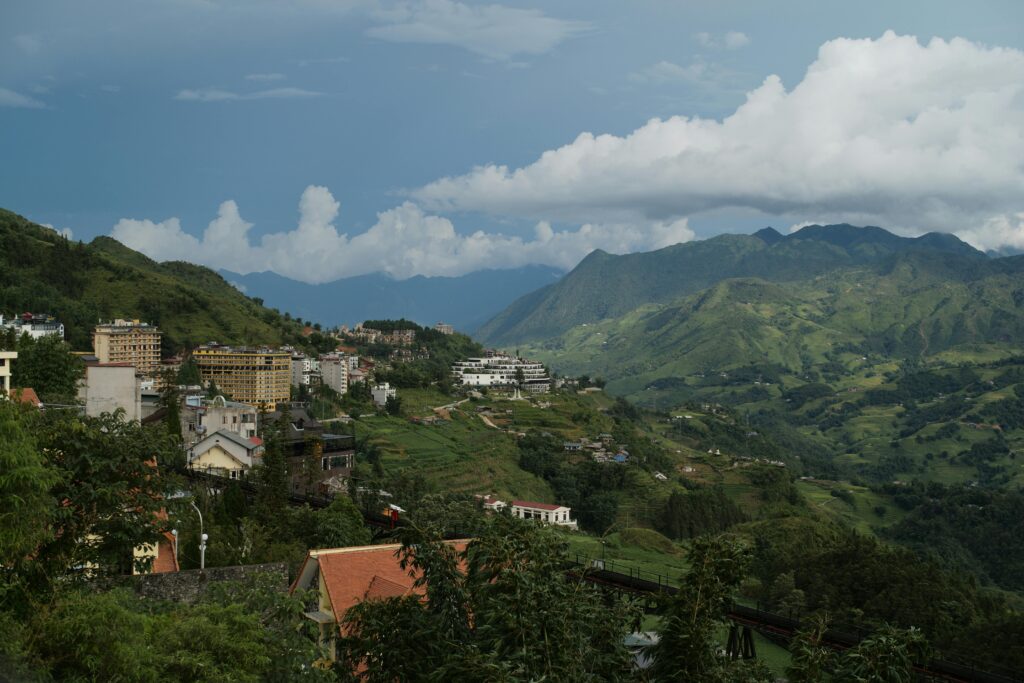 Panoramic view of Lào Cai's lush mountains and town, perfect for travel inspiration.