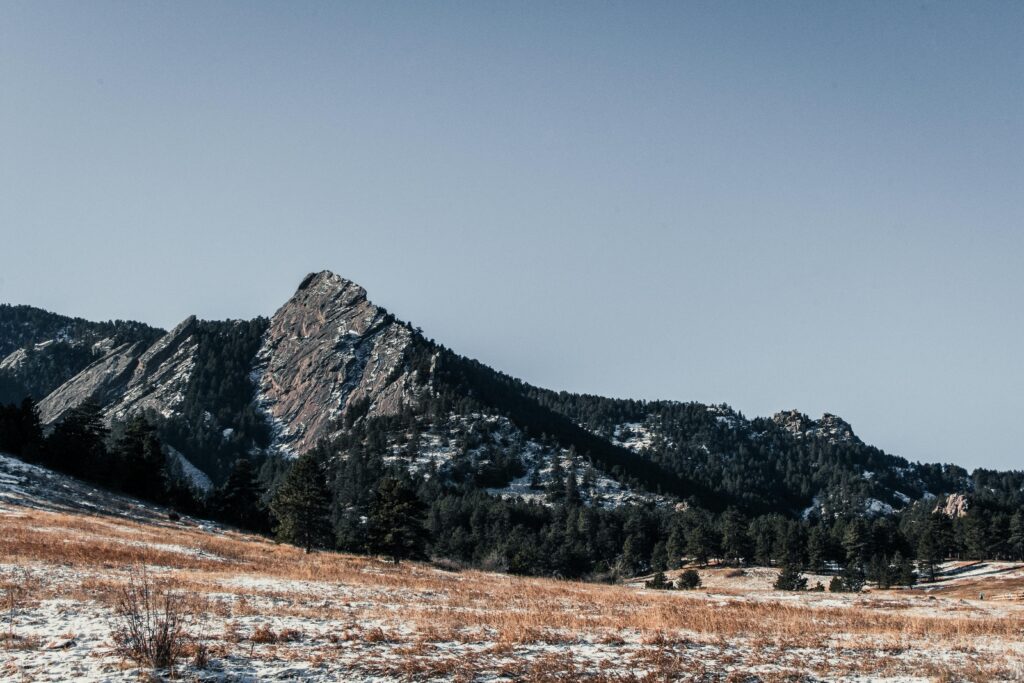 Breathtaking view of a snow-dusted mountain during winter, captured at sunrise.