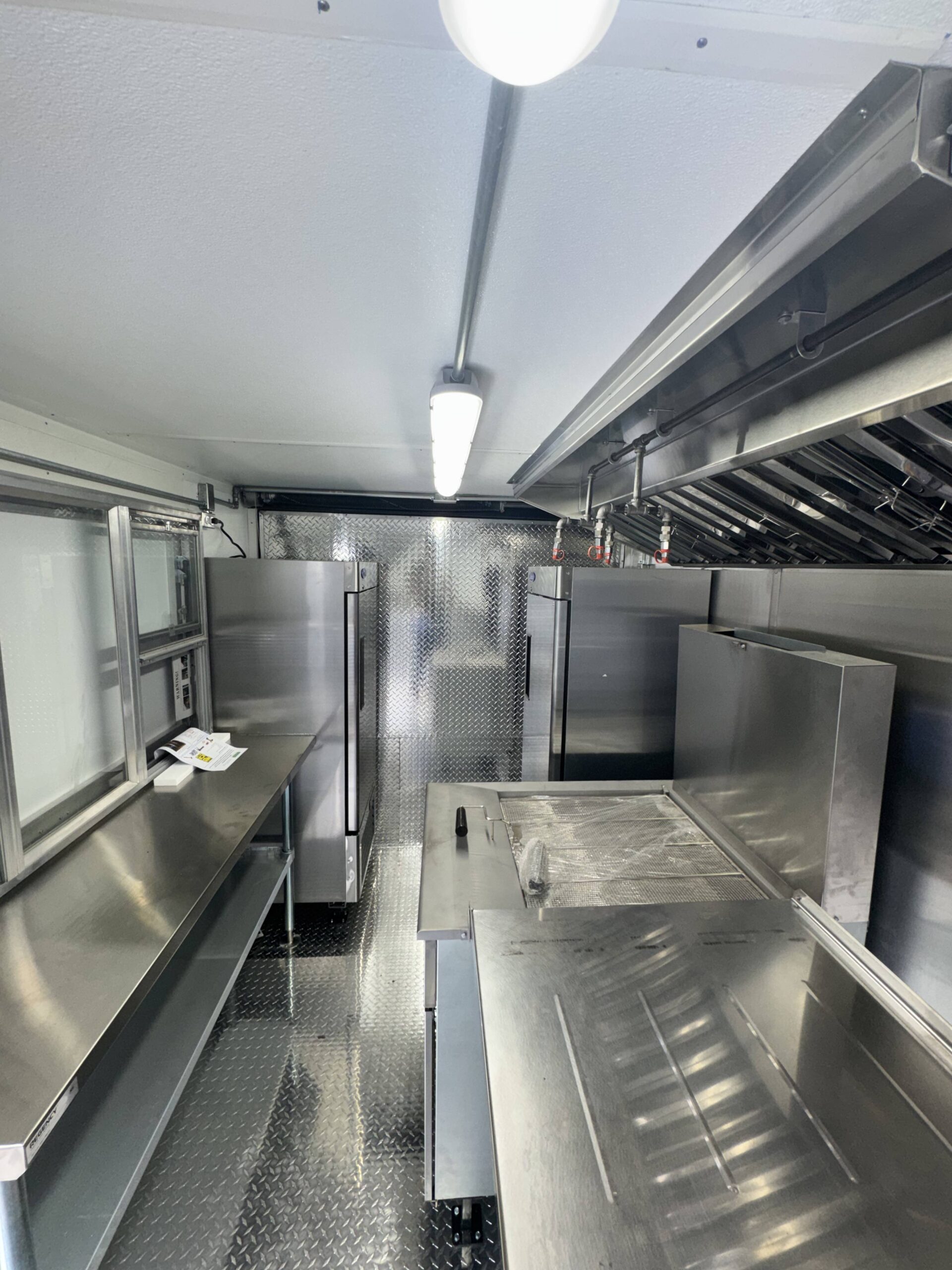 Food trailer interior showing service window counter and equipment layout