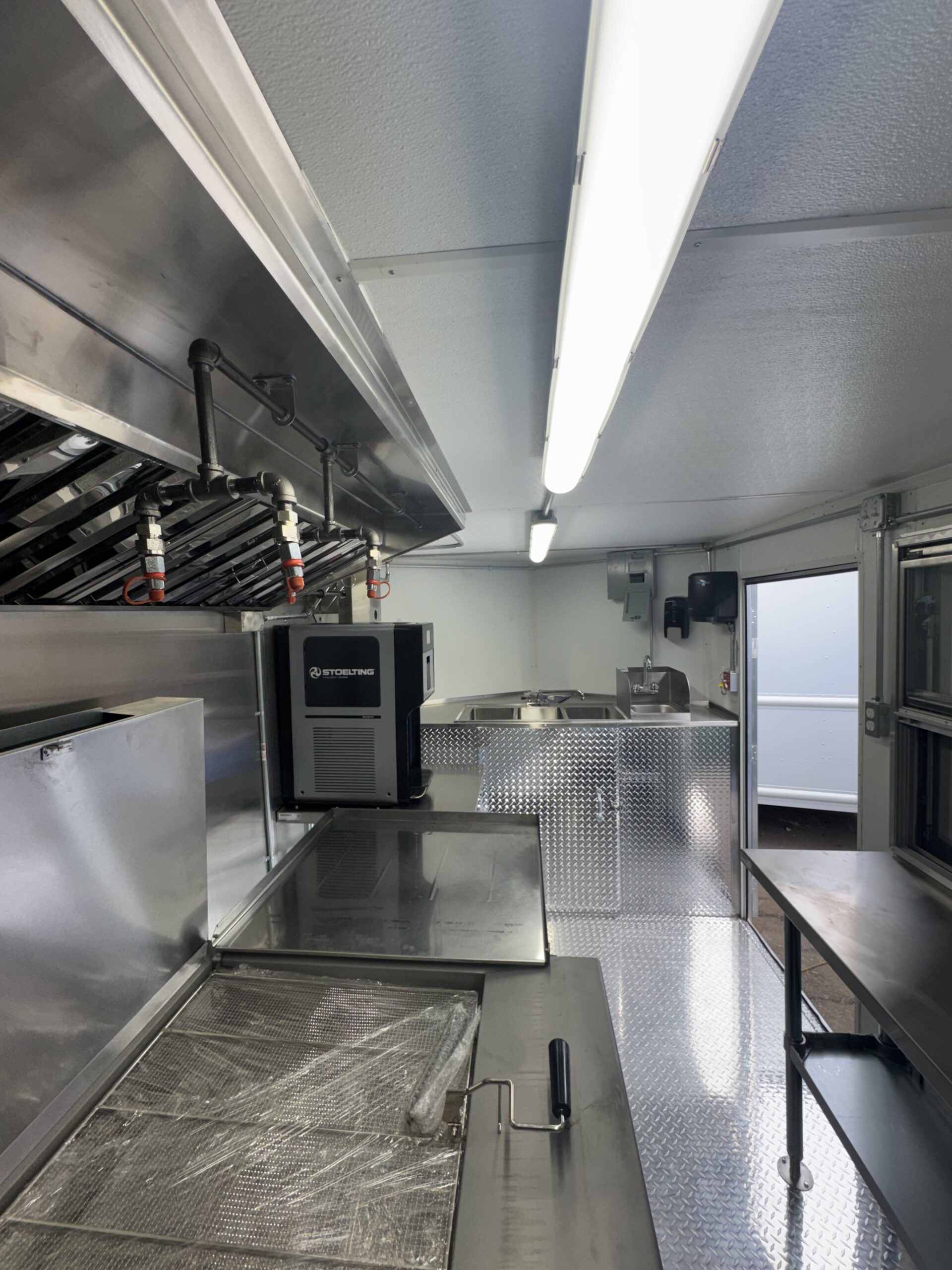 Full interior view with fryer ice cream machine sinks and LED lighting