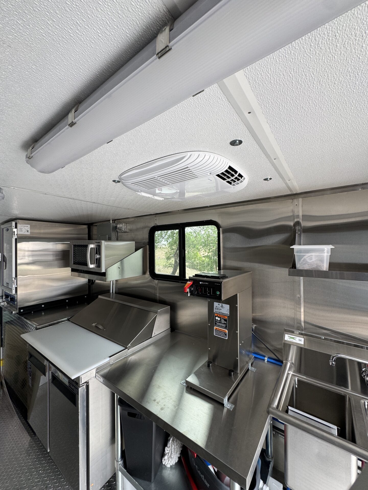 Interior of the Hot-Tok Korean food truck showing the refrigerated prep table area near the service window