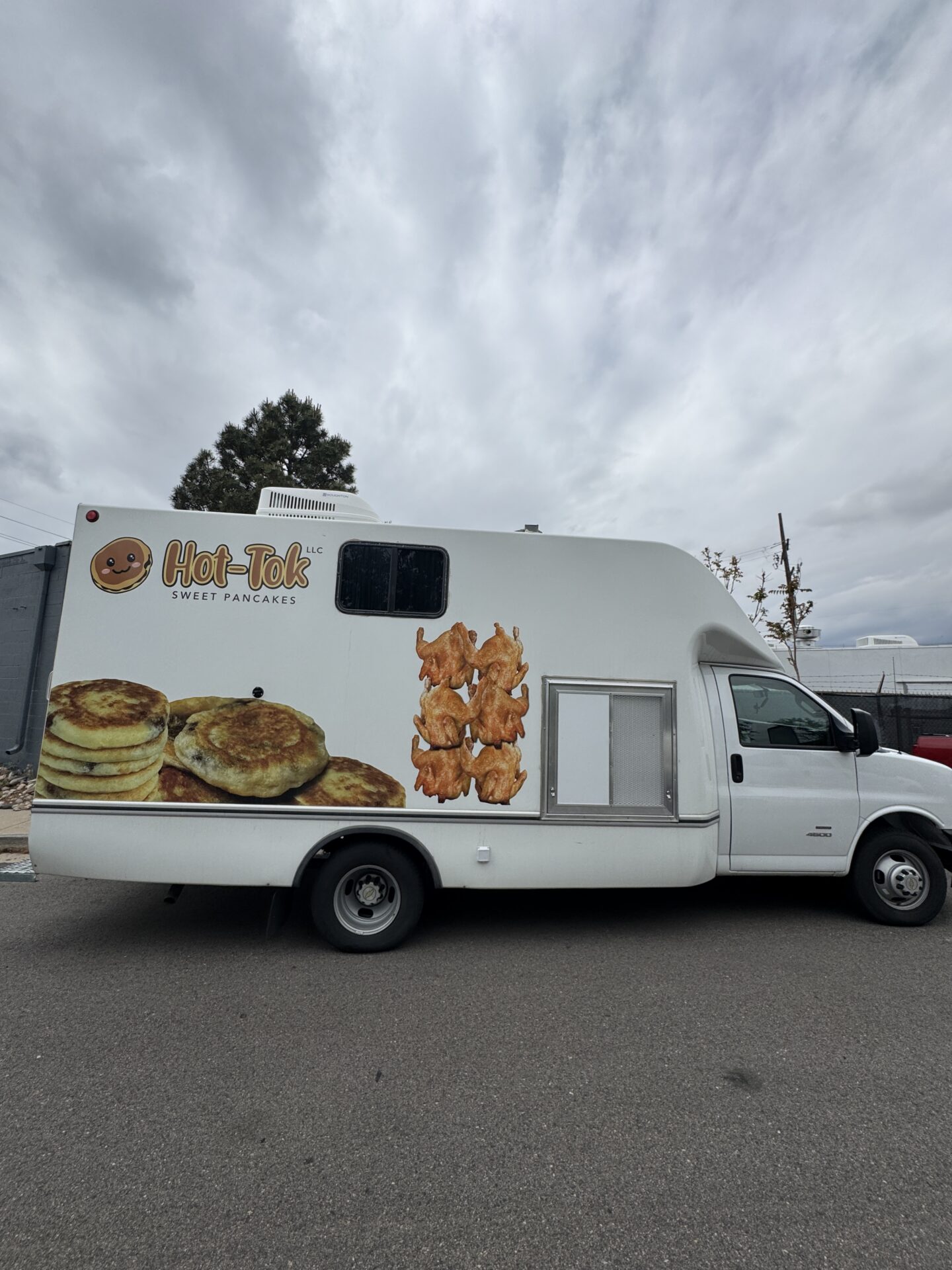 Rear of the Hot-Tok Korean food truck showing the bear mascot, Hot-Tok logo, and Korean fried chicken art