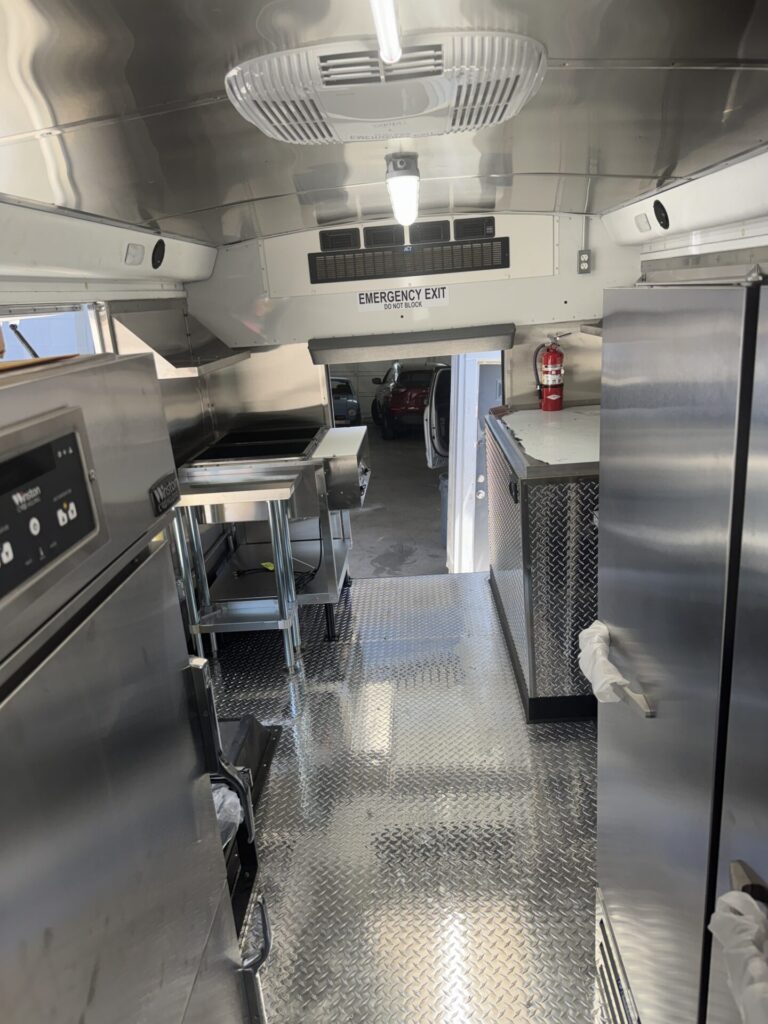 Stainless interior of a school bus to food bus conversion