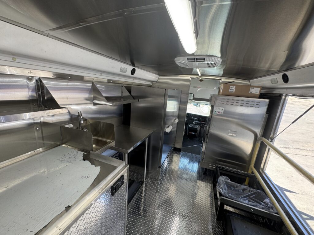 Interior of the food bus with refrigeration and stainless counters