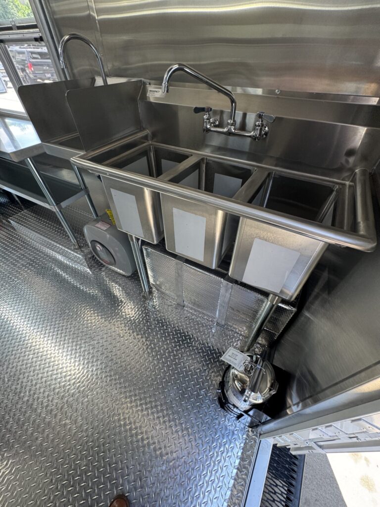 Hand-wash and three-compartment sinks inside the truck