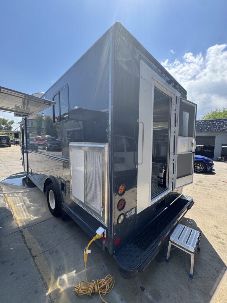 Rear of the catering truck with the service window and awning open
