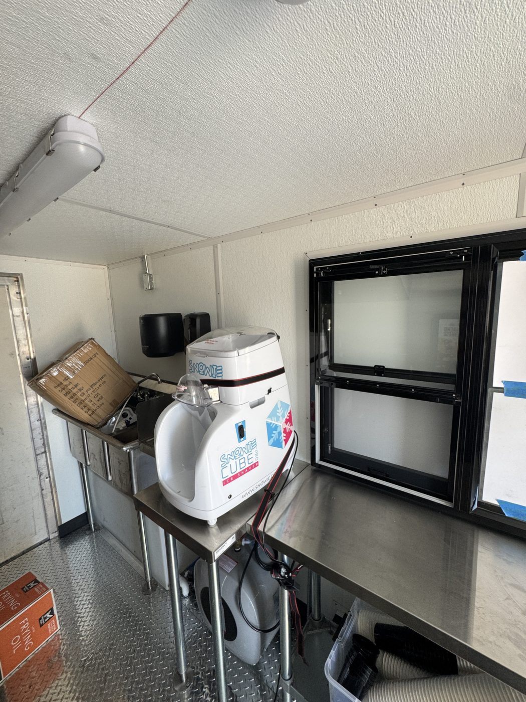 Hand wash sink, dispensers and the service window inside the Sweetly Roasted corn truck