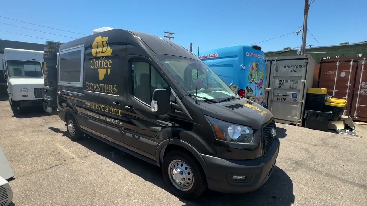 Front three quarter view of the all electric coffee van showing the self closing service window