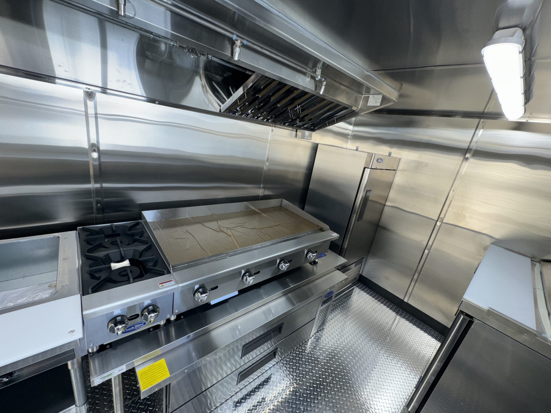 48 inch Atosa griddle and two burner hotplate on a refrigerated chef base under the hood