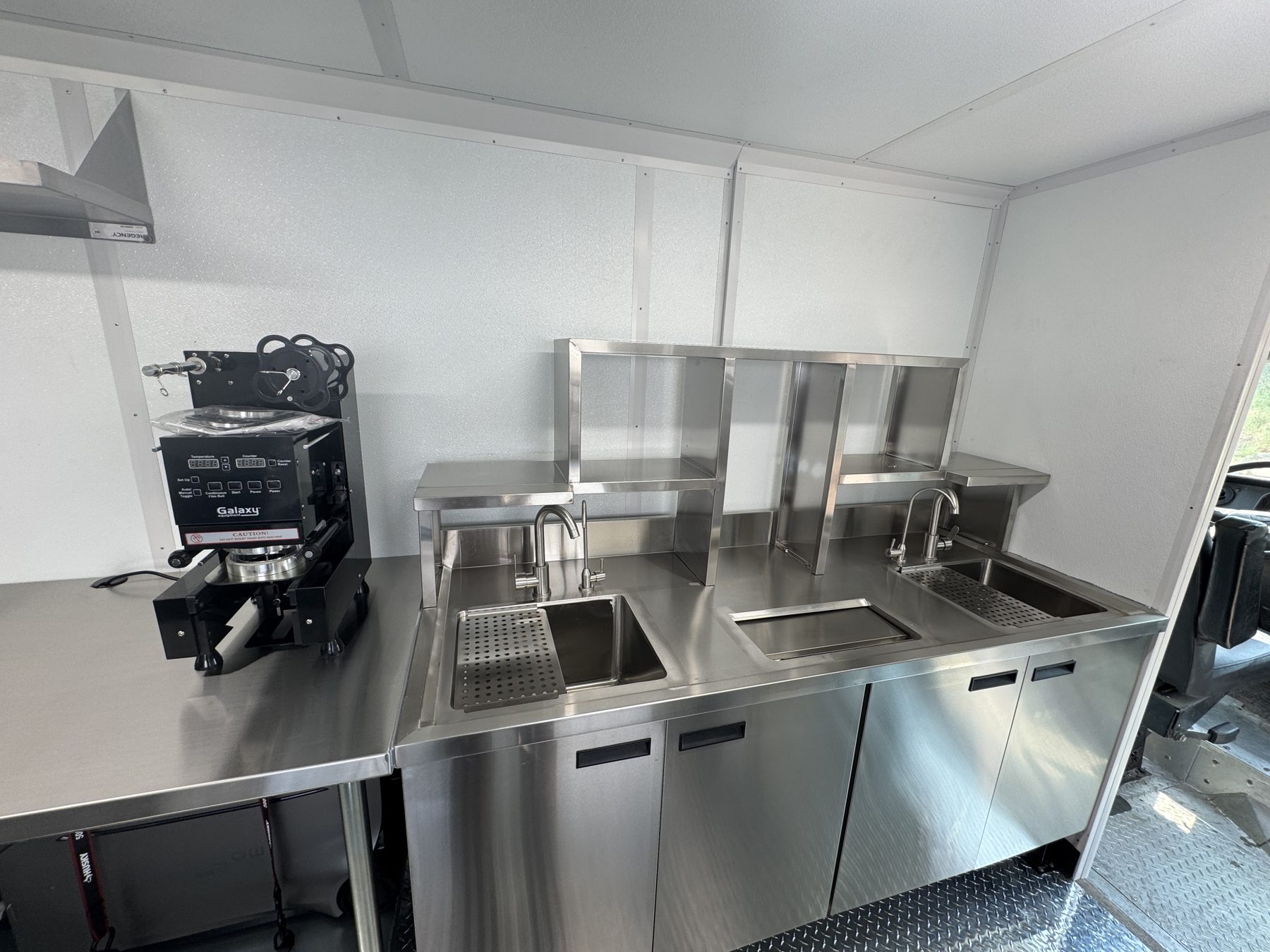 Automatic cup sealing machine beside the bubble tea workstation