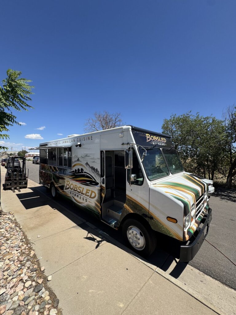 Front three quarter view of the twenty foot Jamaican jerk chicken food truck built for Laramie, Wyoming