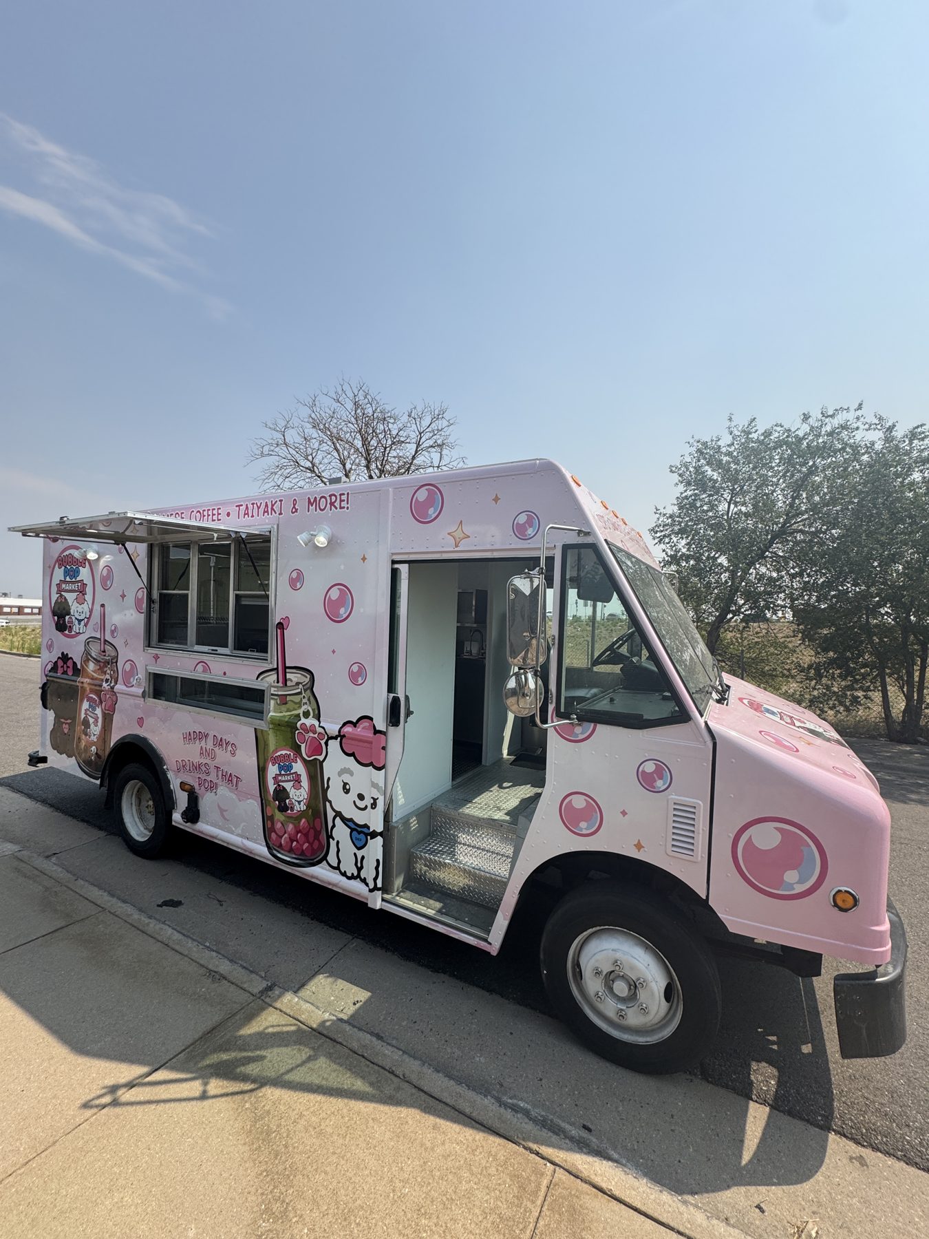 Pink 14ft boba tea food truck built for Bubble Pop Market in Fort Collins, Colorado, with the service window and door open