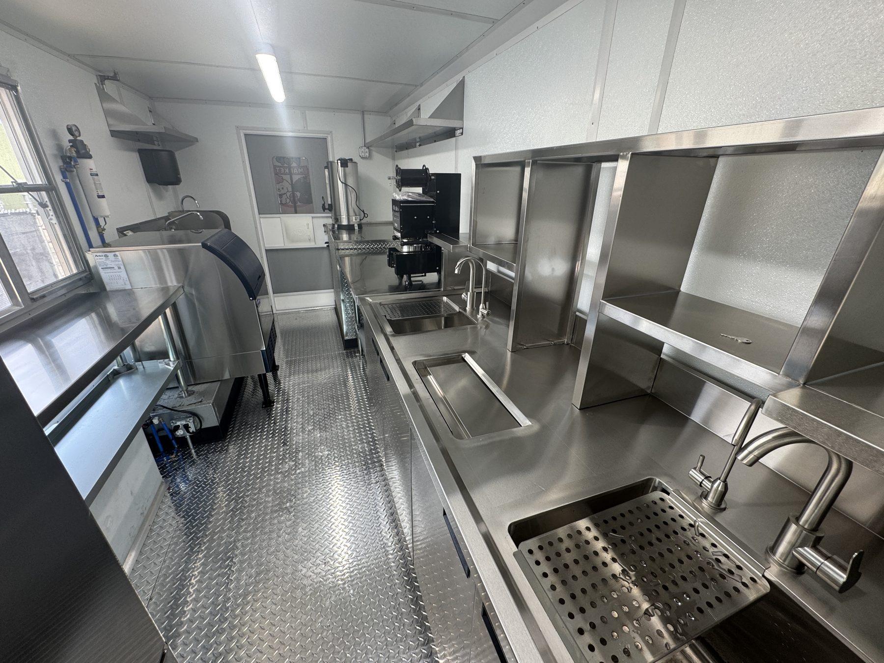 Stainless bubble tea workstation with hot and cold water taps and a drip tray