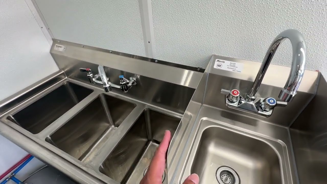 Three compartment sink and hand wash sink with splash guard inside the all electric coffee van