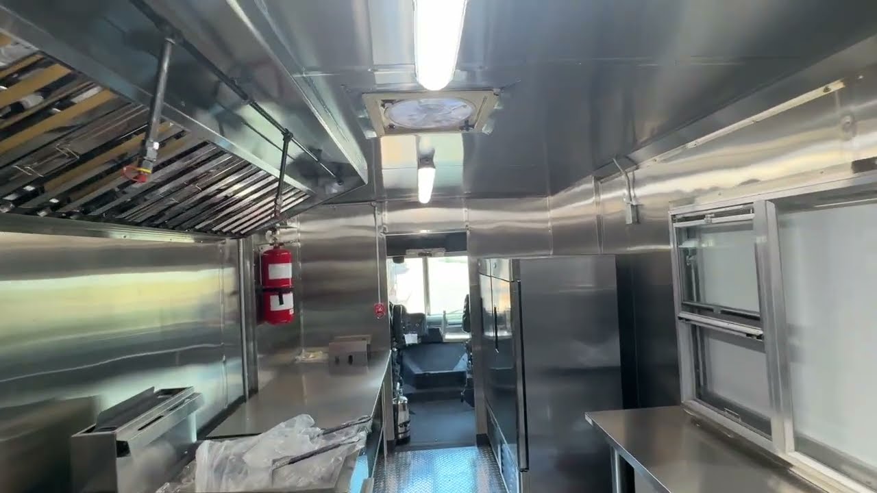 Stainless interior of the 14ft smashburger food truck showing the 8ft exhaust hood and the cook line