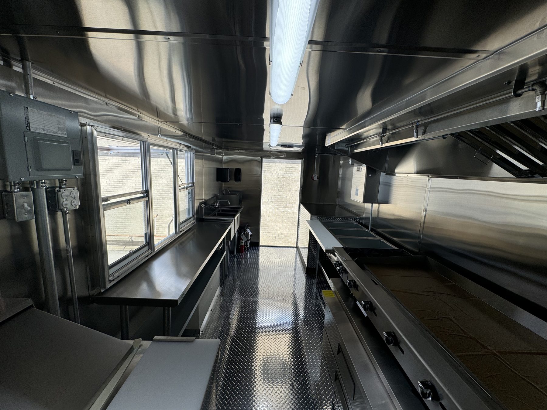 Service window and counter with the breaker panel, looking down the length of the taco truck