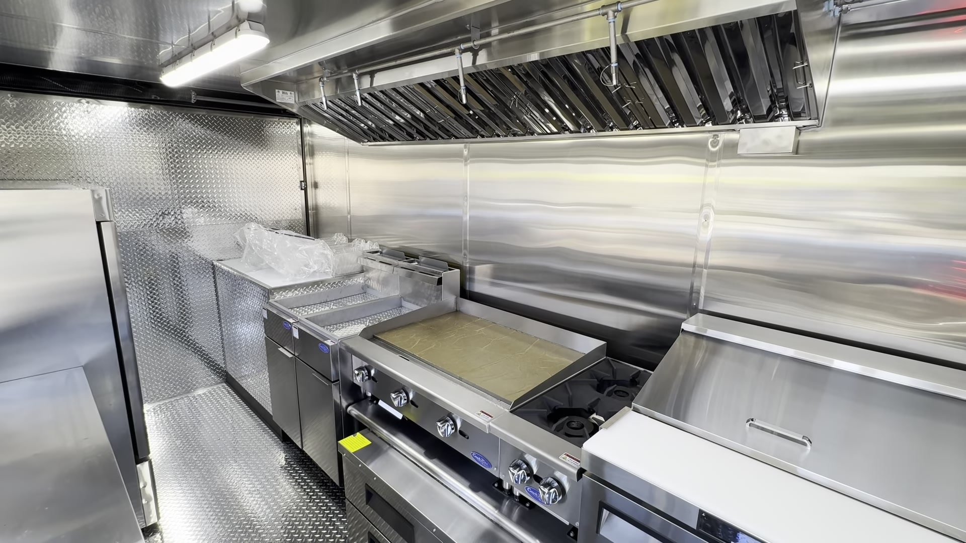 Cook line of the 16ft food trailer with griddle, hotplate and fryers under the hood
