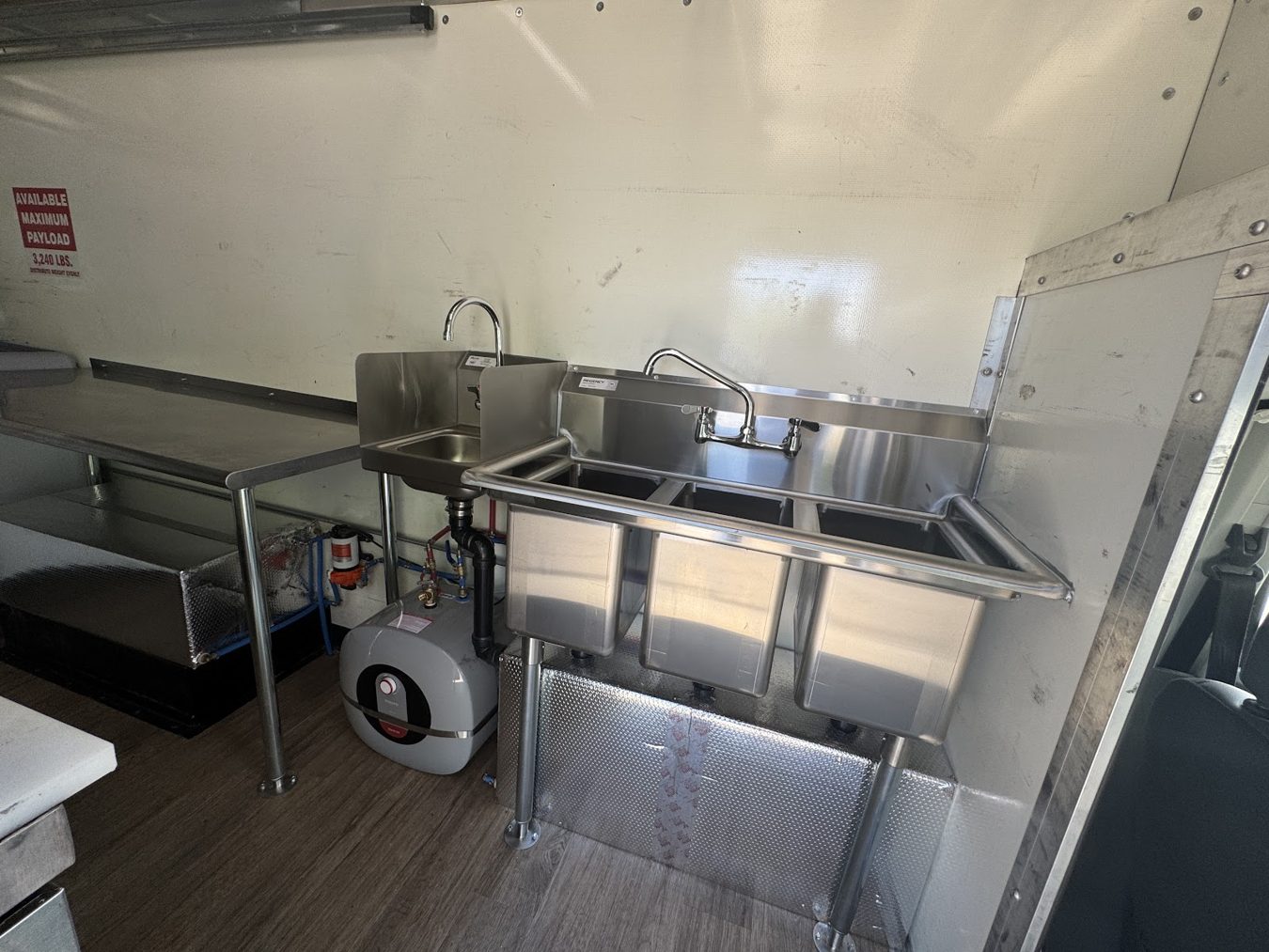 Three compartment sink, hand sink and water heater inside the açaí bowl food truck
