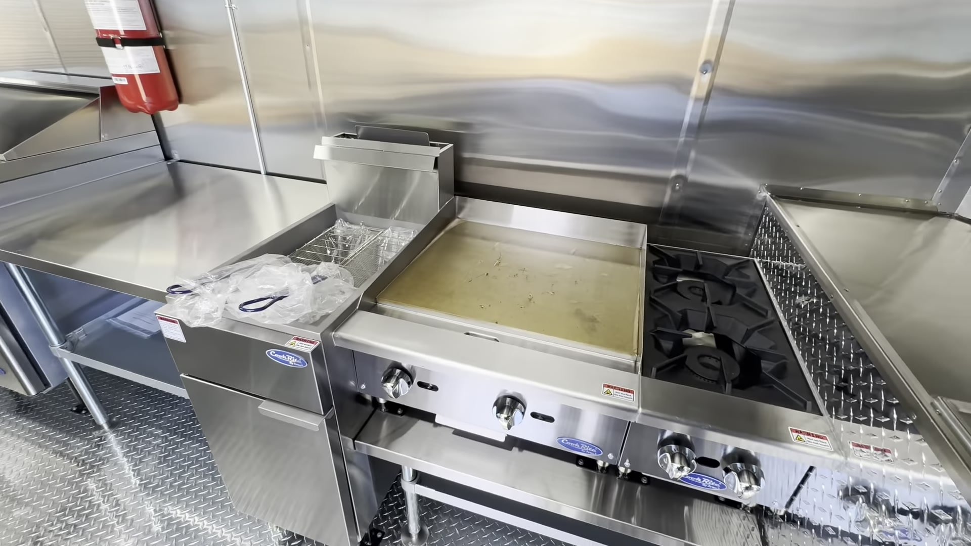 Atosa CookRite 24 inch griddle, two burner hotplate and floor fryer on the cook line of the 12ft trailer