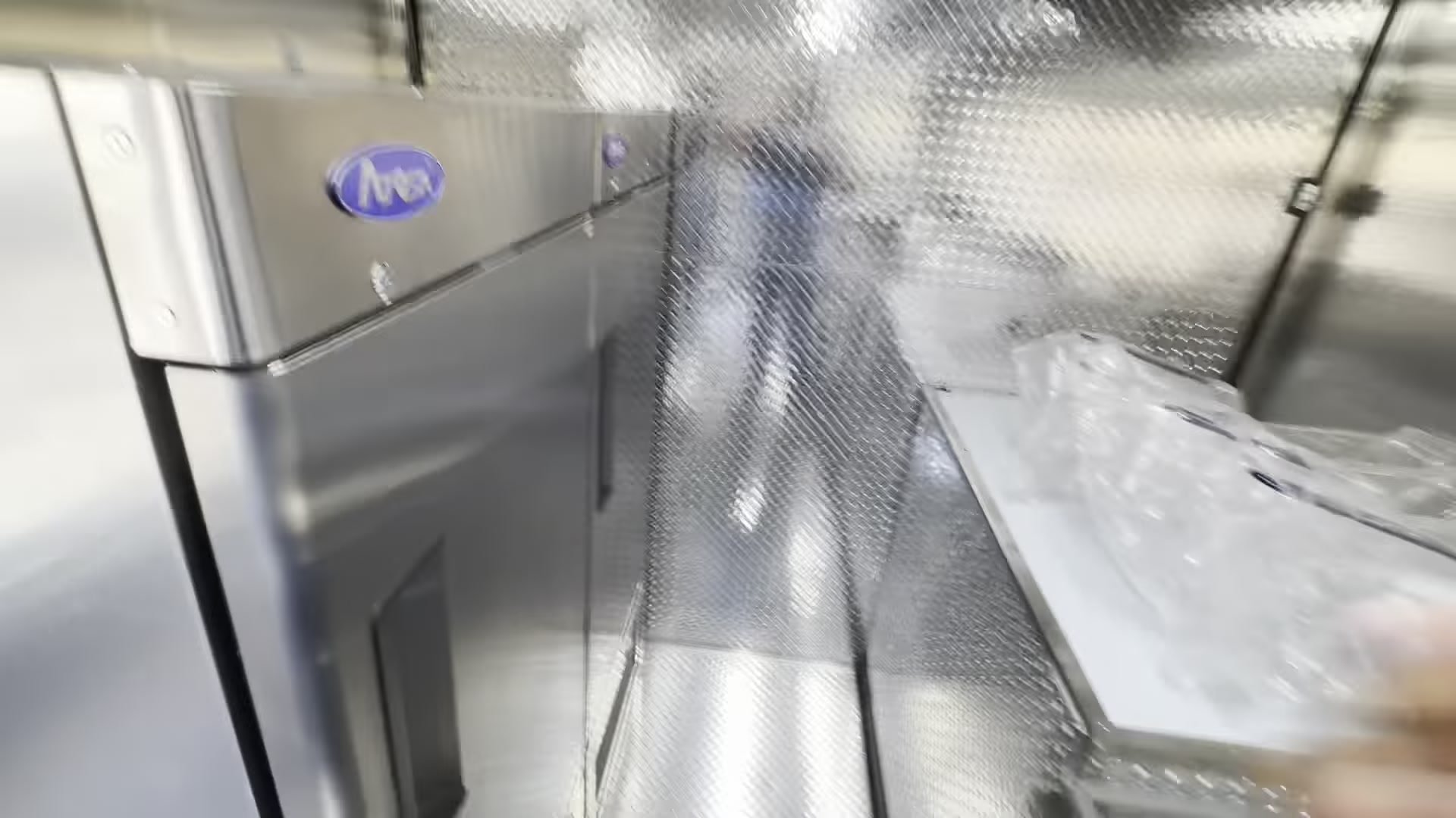 Atosa standup refrigerator in the food trailer placed so its door opens fully