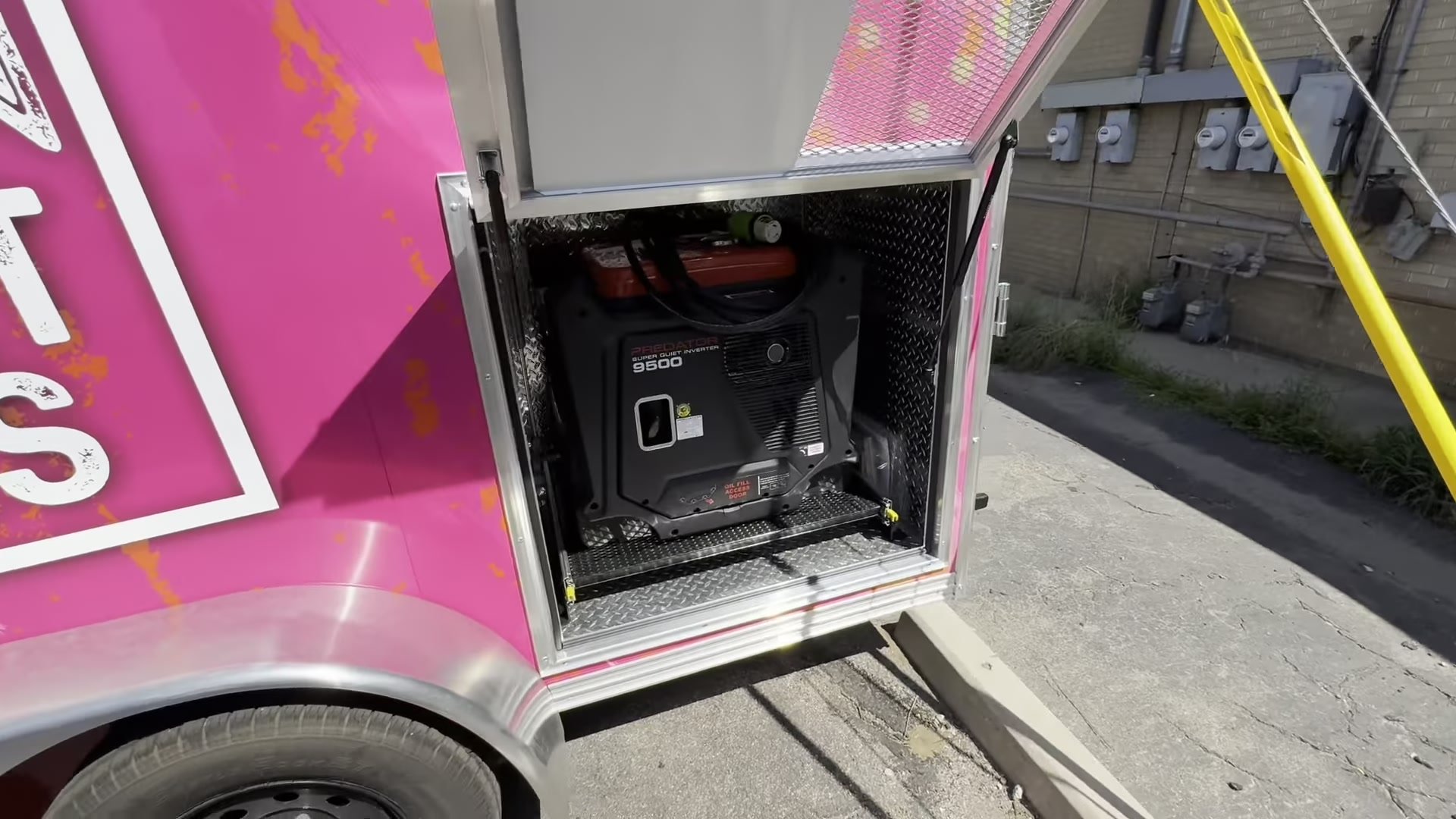 Generator on a pull out tray in a lockable compartment on the food trailer