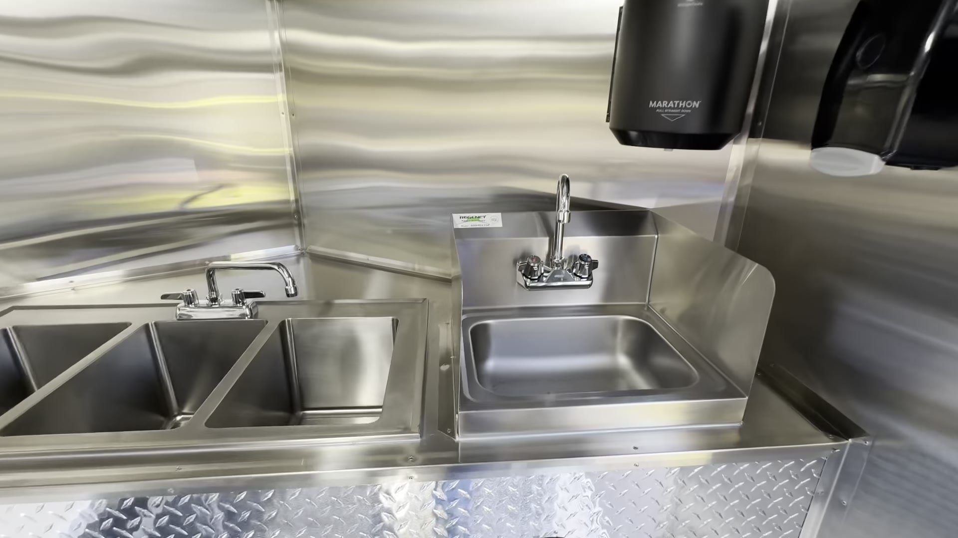 Three compartment sink and hand wash sink with splash guard in the 16ft trailer