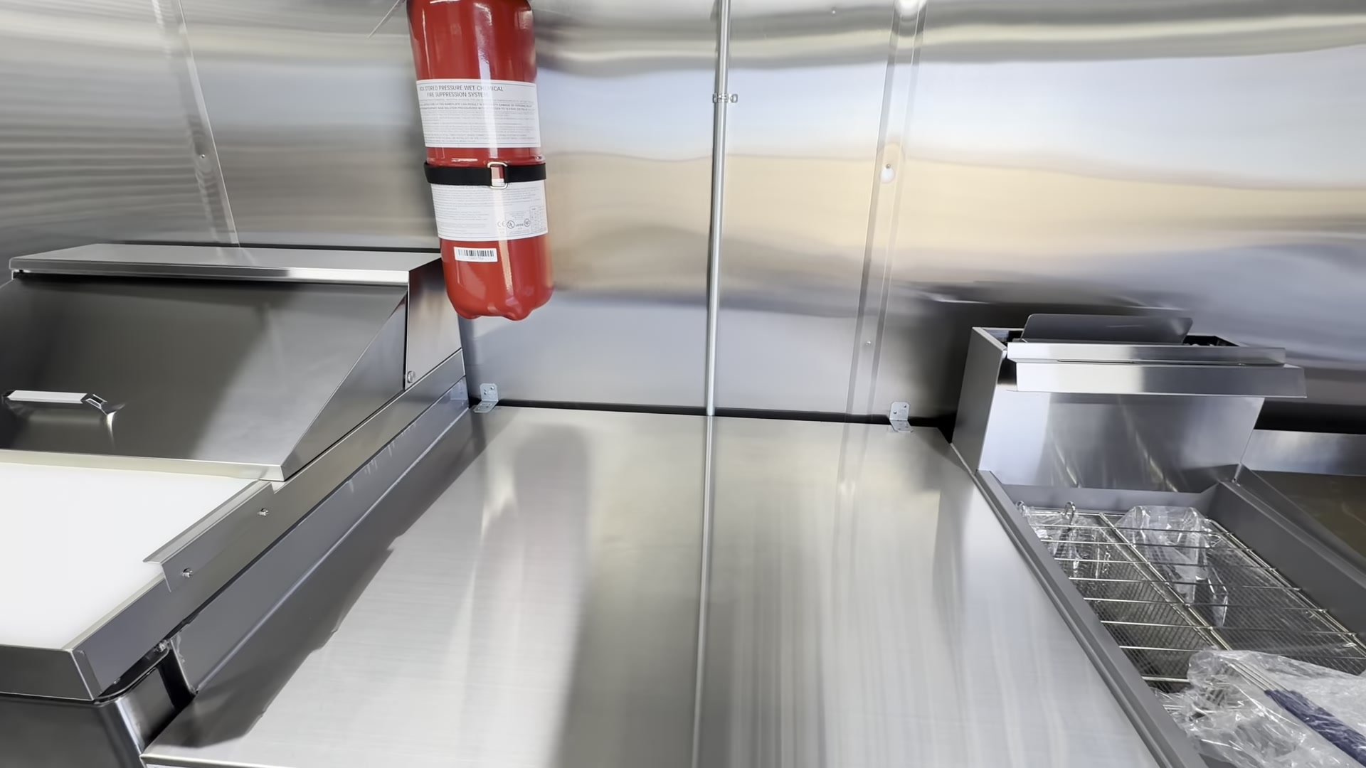 Stainless work table on the cook line with room for an espresso machine next to the fryer