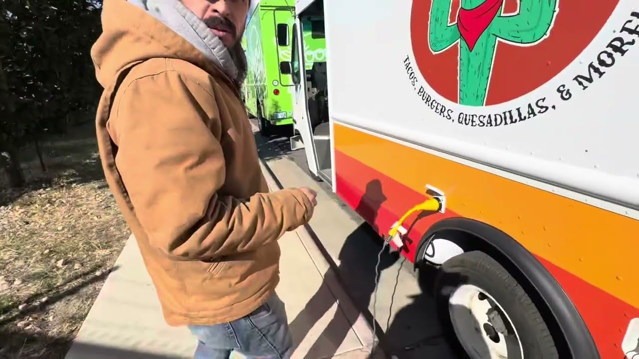 Opening the access panel to the underbelly propane tank on a food truck