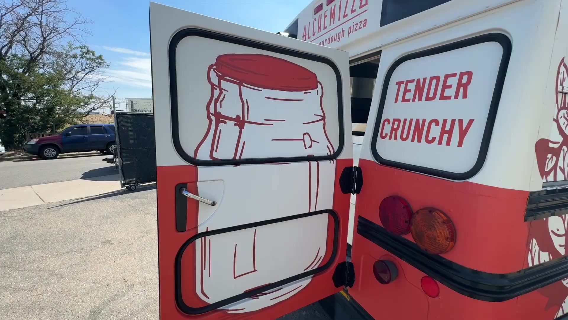 Rear doors of the pizza food bus wrapped with Tender and Crunchy panels