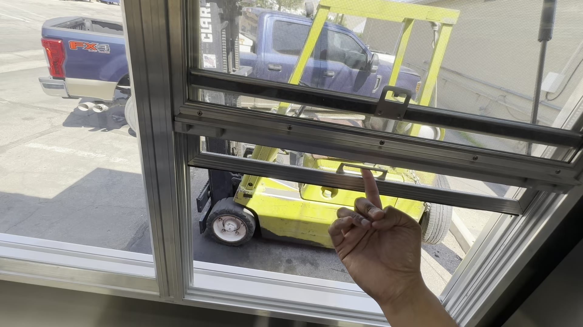 Self closing three section service window with plate glass panes in the food trailer