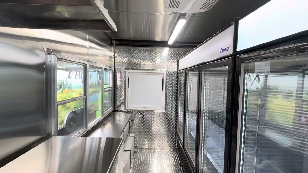 Inside the 12 foot drinks trailer with stainless counters and glass door refrigeration